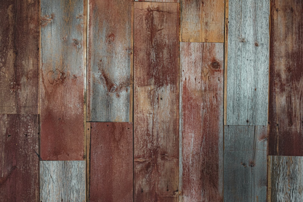 a close up of a wooden wall with a clock on it