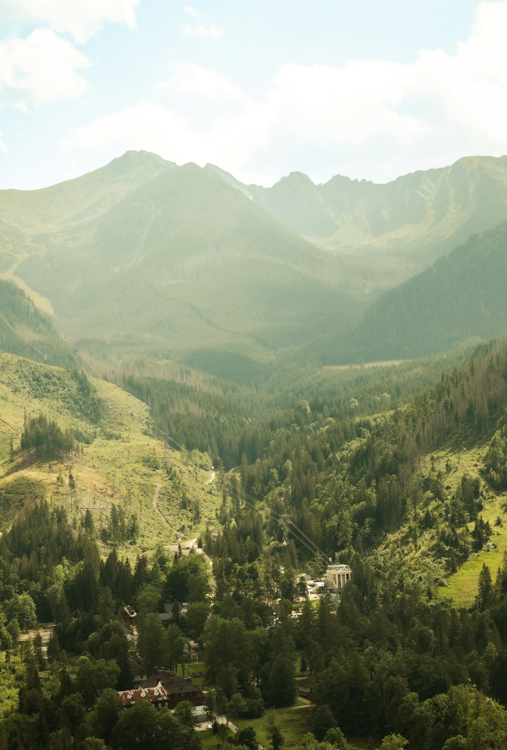 a view of a valley with mountains in the background