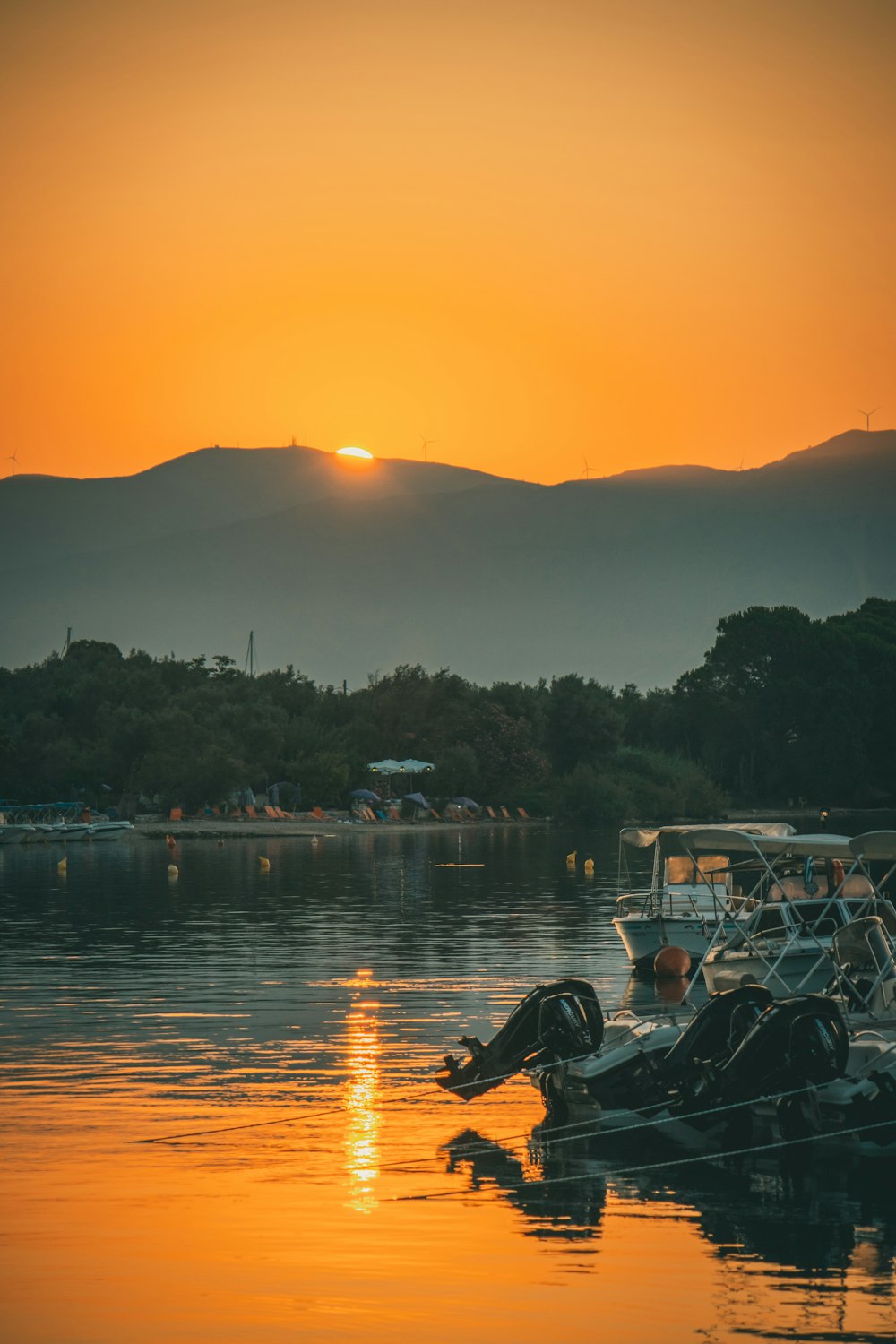 a group of boats floating on top of a lake