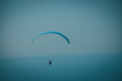 a person parasailing in the ocean on a foggy day