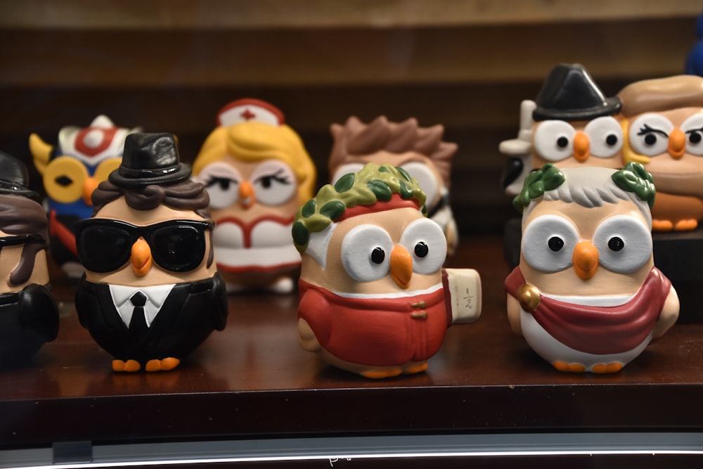 a group of small figurines of people wearing hats and glasses