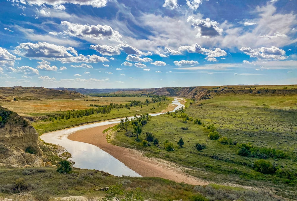 a river running through a lush green valley