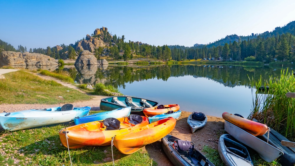 a group of canoes sitting on the shore of a lake