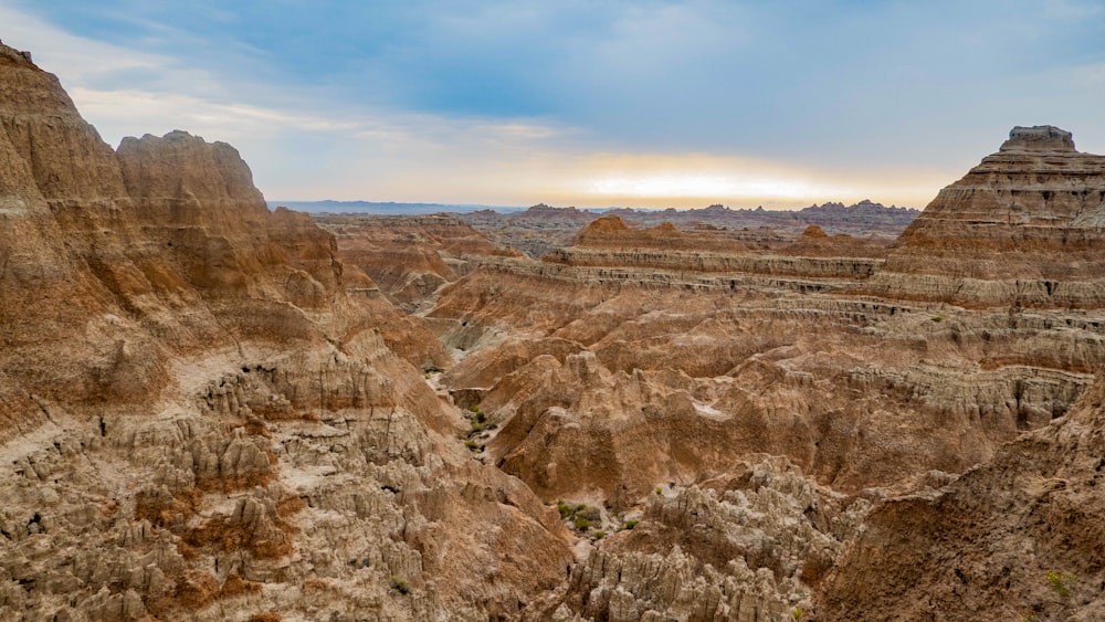 the sun is setting over the canyons of the badlands