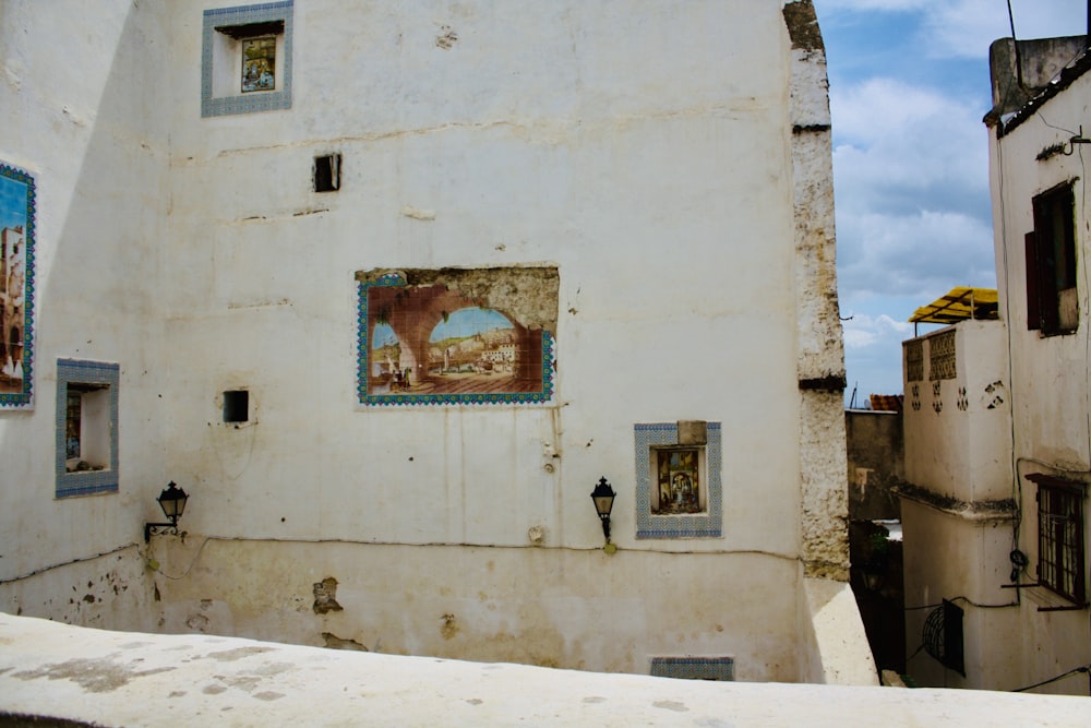 a white building with a painting on the side of it