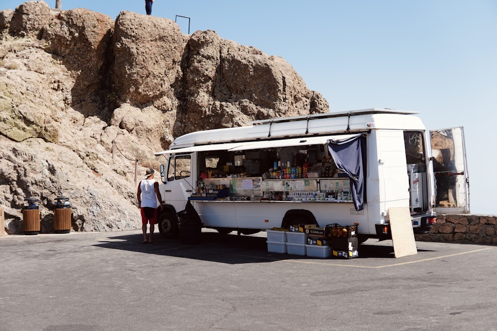 a man standing in front of a food truck