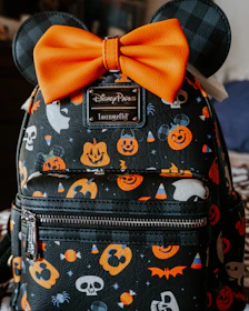 a mickey mouse backpack with a bow on it