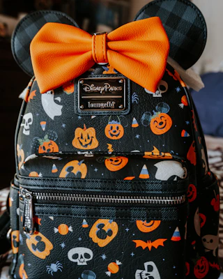 a mickey mouse backpack with a bow on it