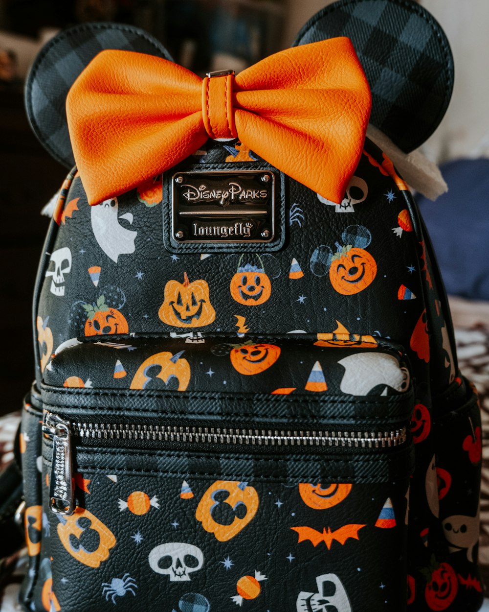 a mickey mouse backpack with a bow on it