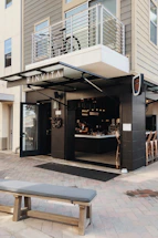 A welcoming coffee shop entrance with a sign that says 'Contact Us'.