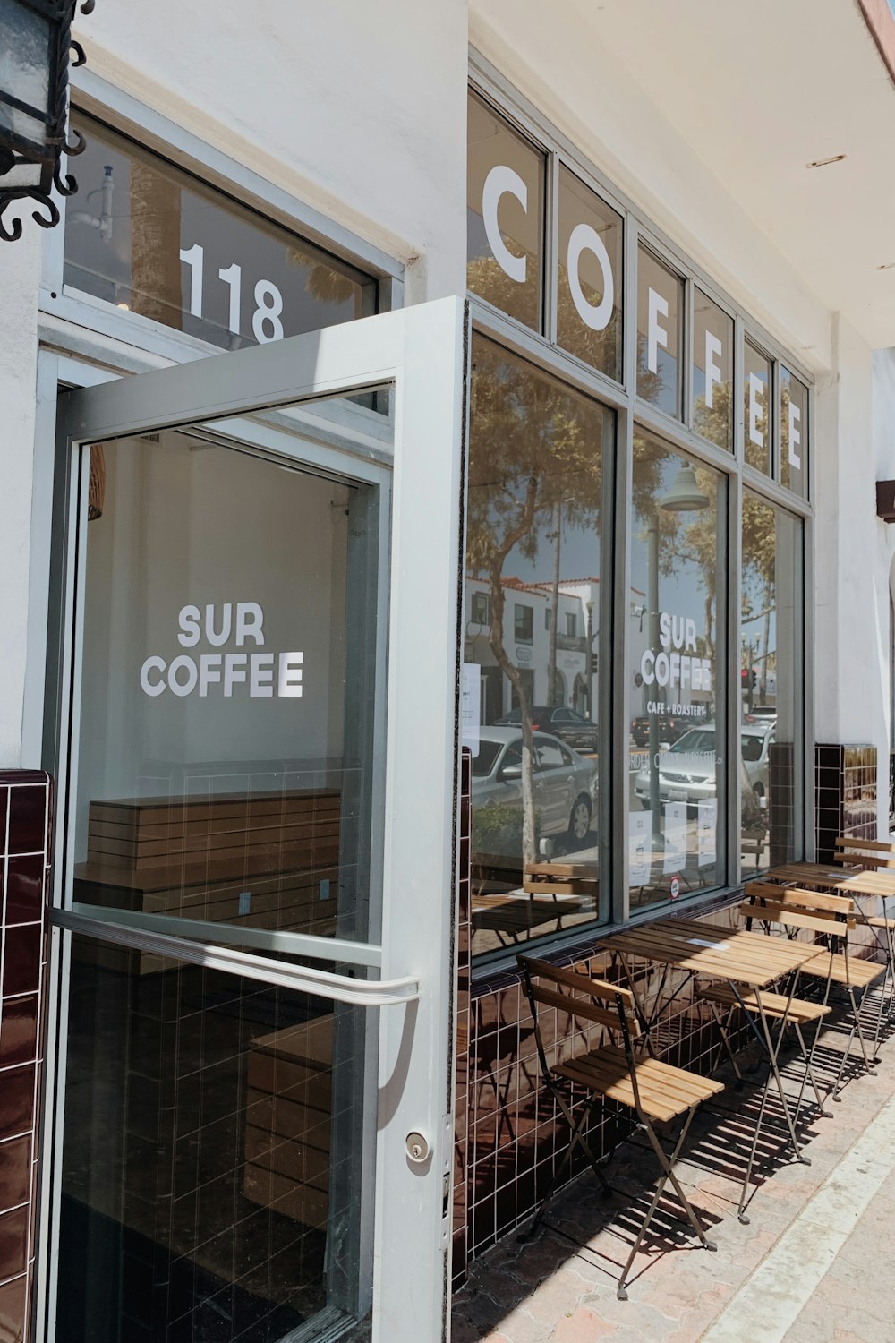 a coffee shop with tables and chairs outside