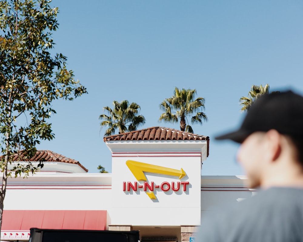 a man standing in front of a fast food restaurant