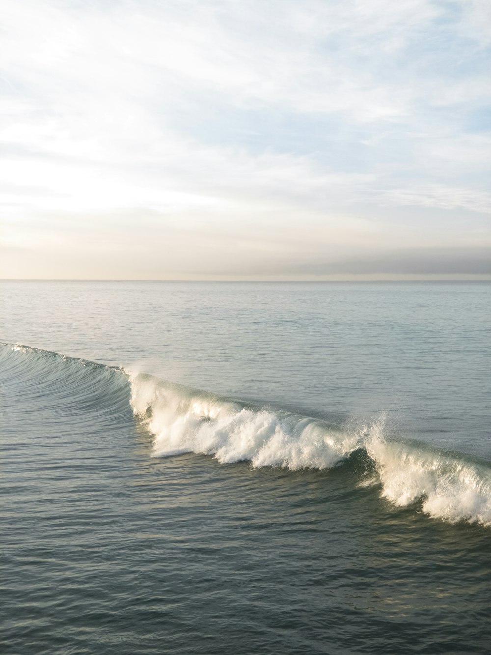 a large wave is coming towards the shore