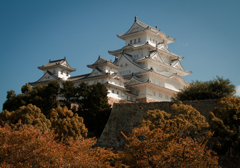 a tall white building sitting on top of a hill