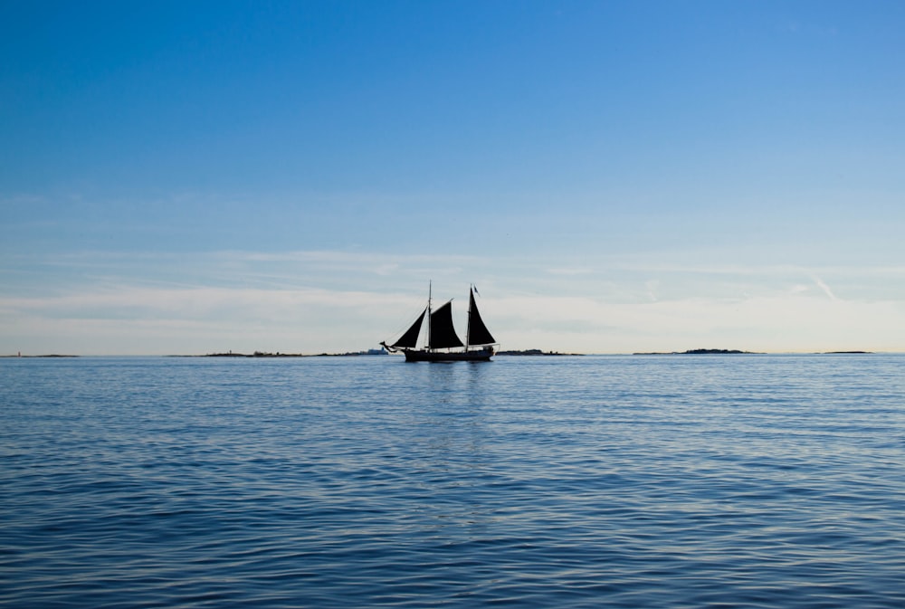 a sailboat in the middle of a body of water