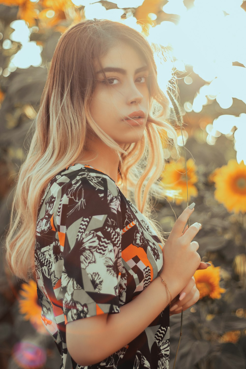 a woman standing in a field of sunflowers