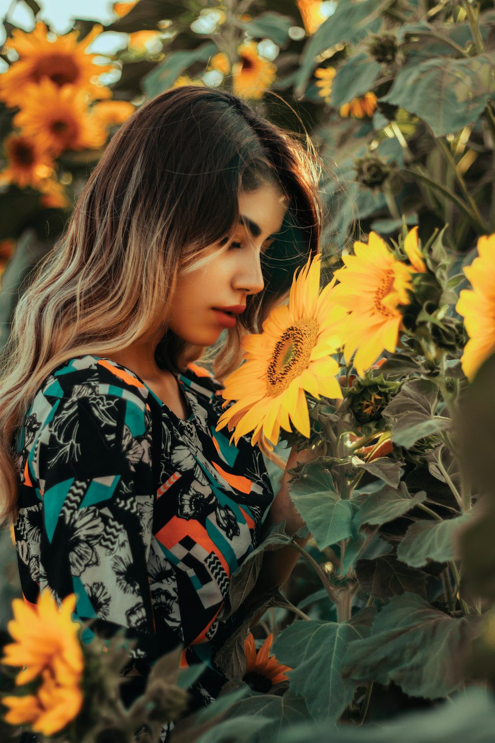 a woman standing in a field of sunflowers