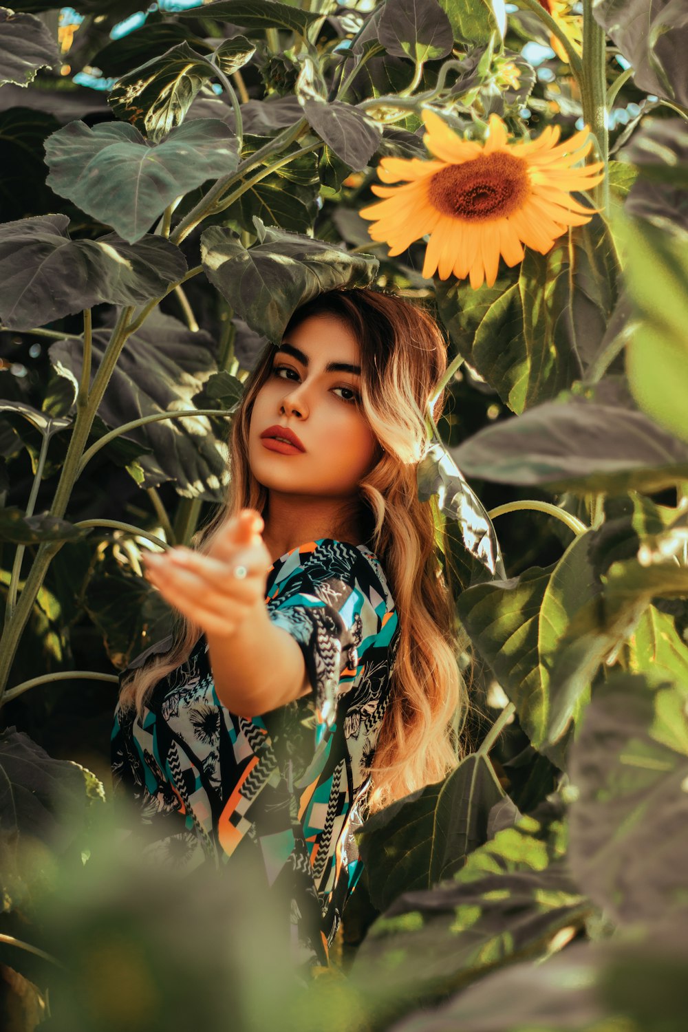 a woman standing in a field of sunflowers