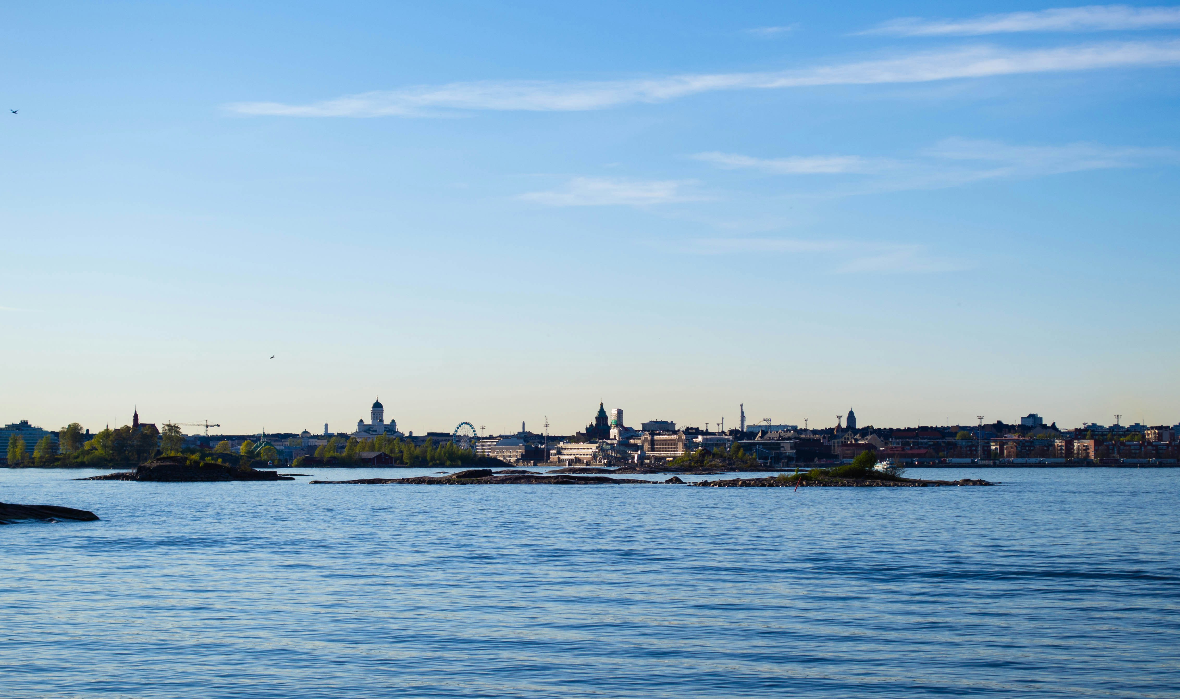 a body of water with a city in the background, 