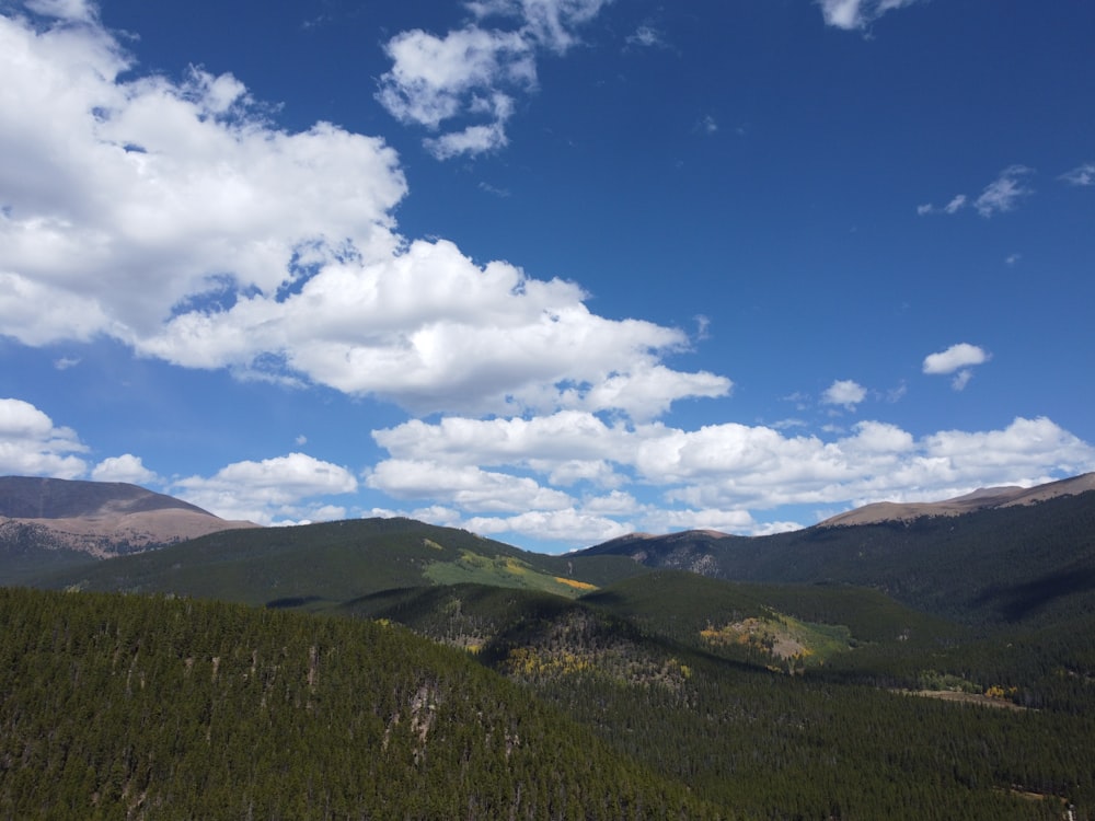 a view of a mountain range with clouds in the sky