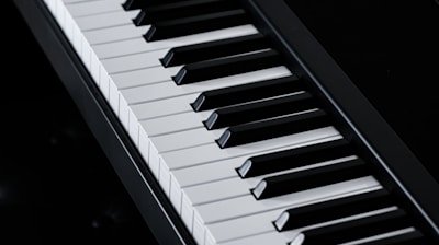 a close up of a piano keyboard on a table