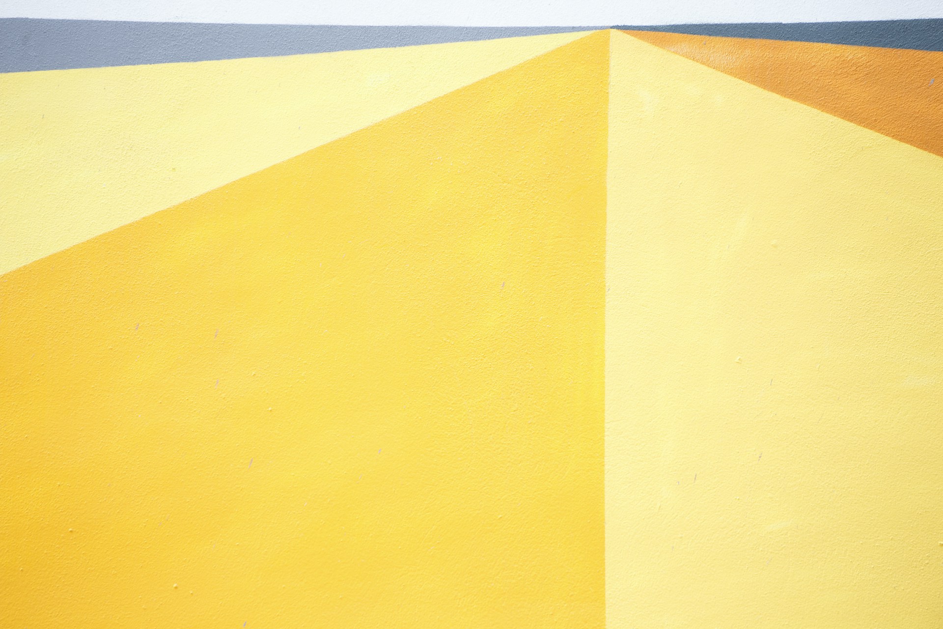 a yellow and blue wall with a clock on it