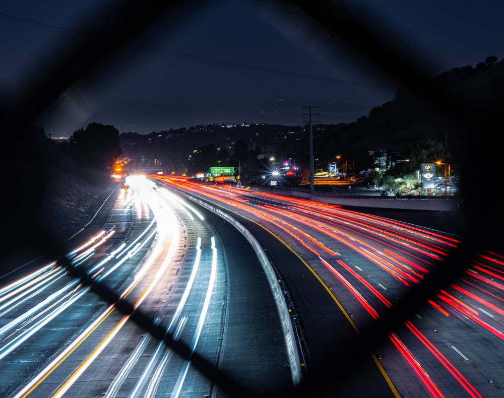 a night time view of a highway with a lot of traffic