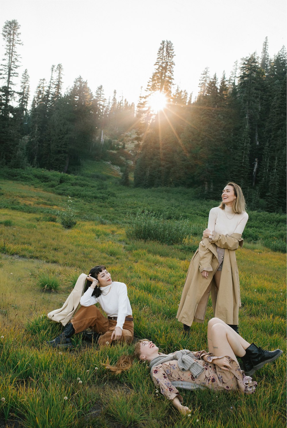 a couple of people that are laying in the grass