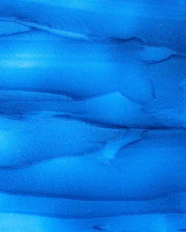 a close up of a blue substance in the water