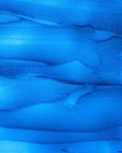 a close up of a blue substance in the water