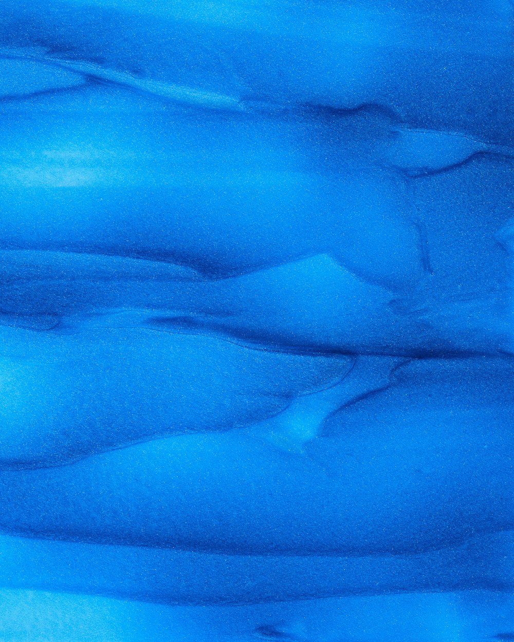 a close up of a blue substance in the water