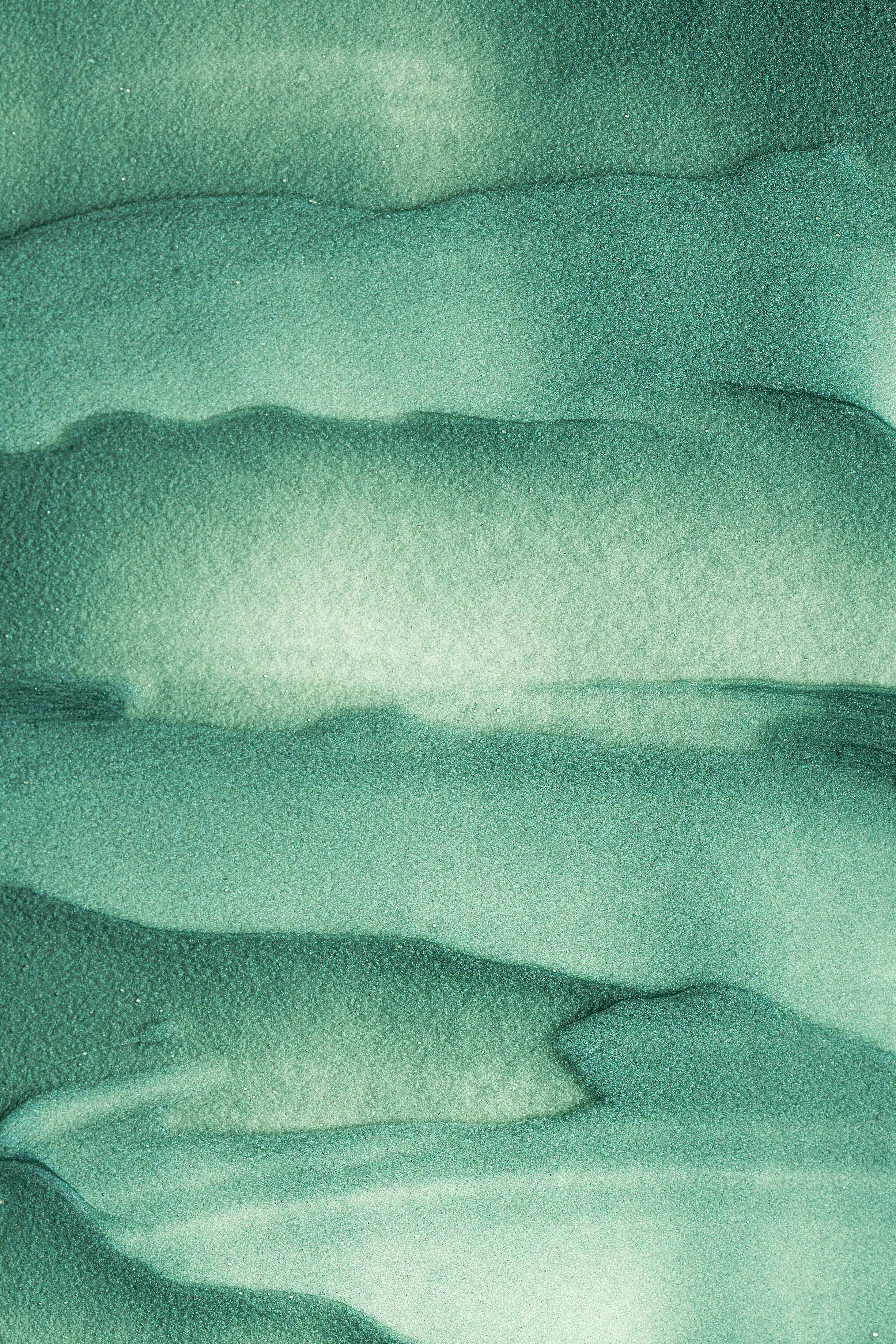 an abstract painting of green and white clouds