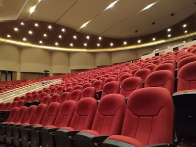 a large auditorium with rows of red seats
