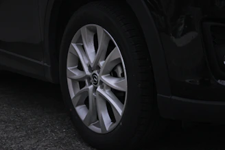 Close-up shot of a high-performance tyre tread with subtle metallic accents reflecting light.