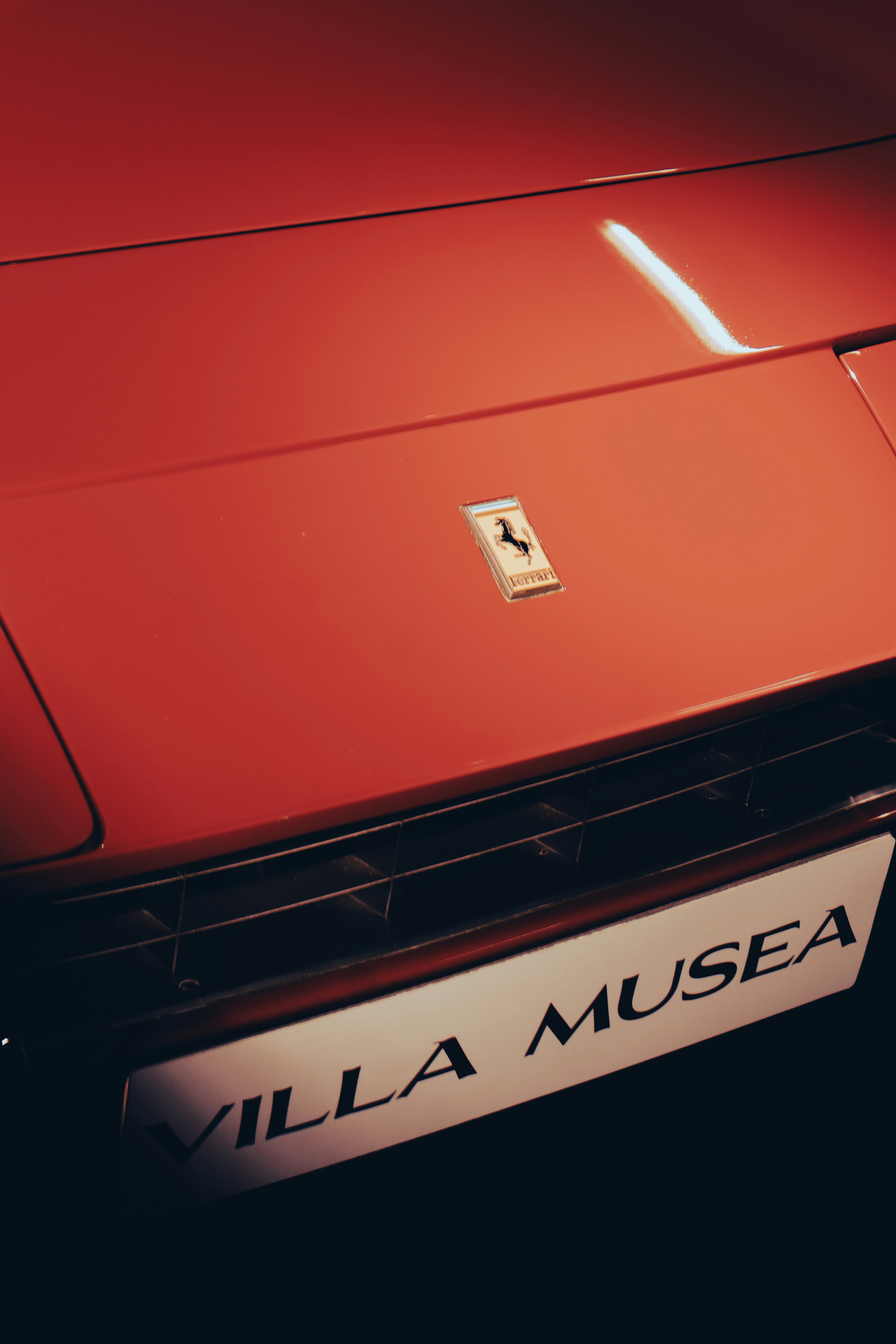 a close up of the front of a red sports car