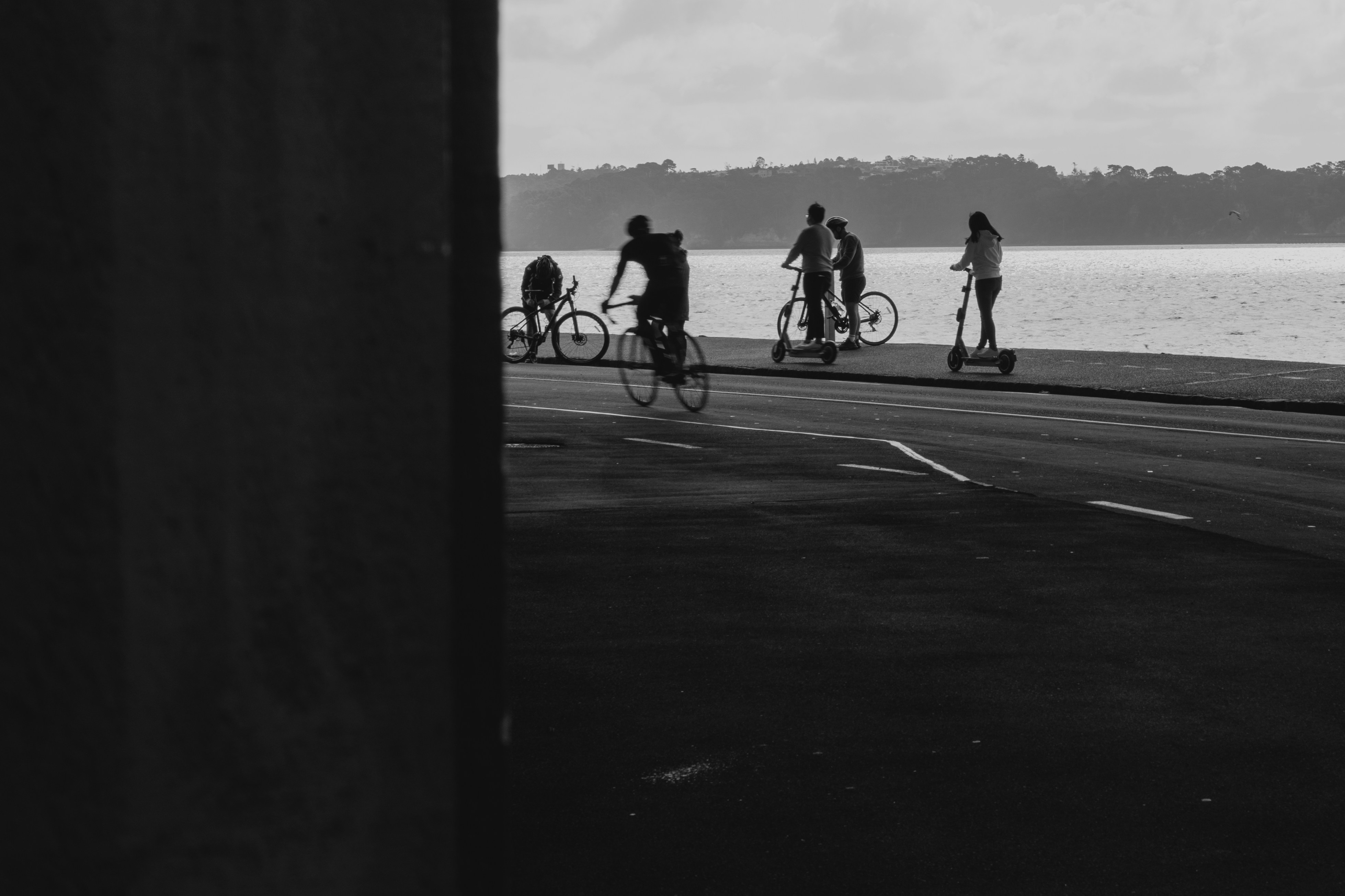 a group of people riding bikes down a street