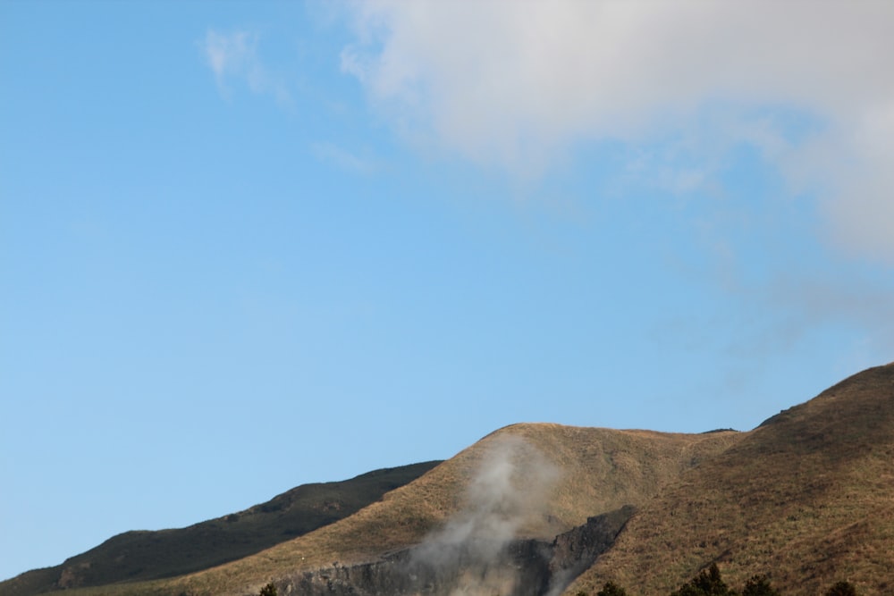 steam rises from the top of a mountain