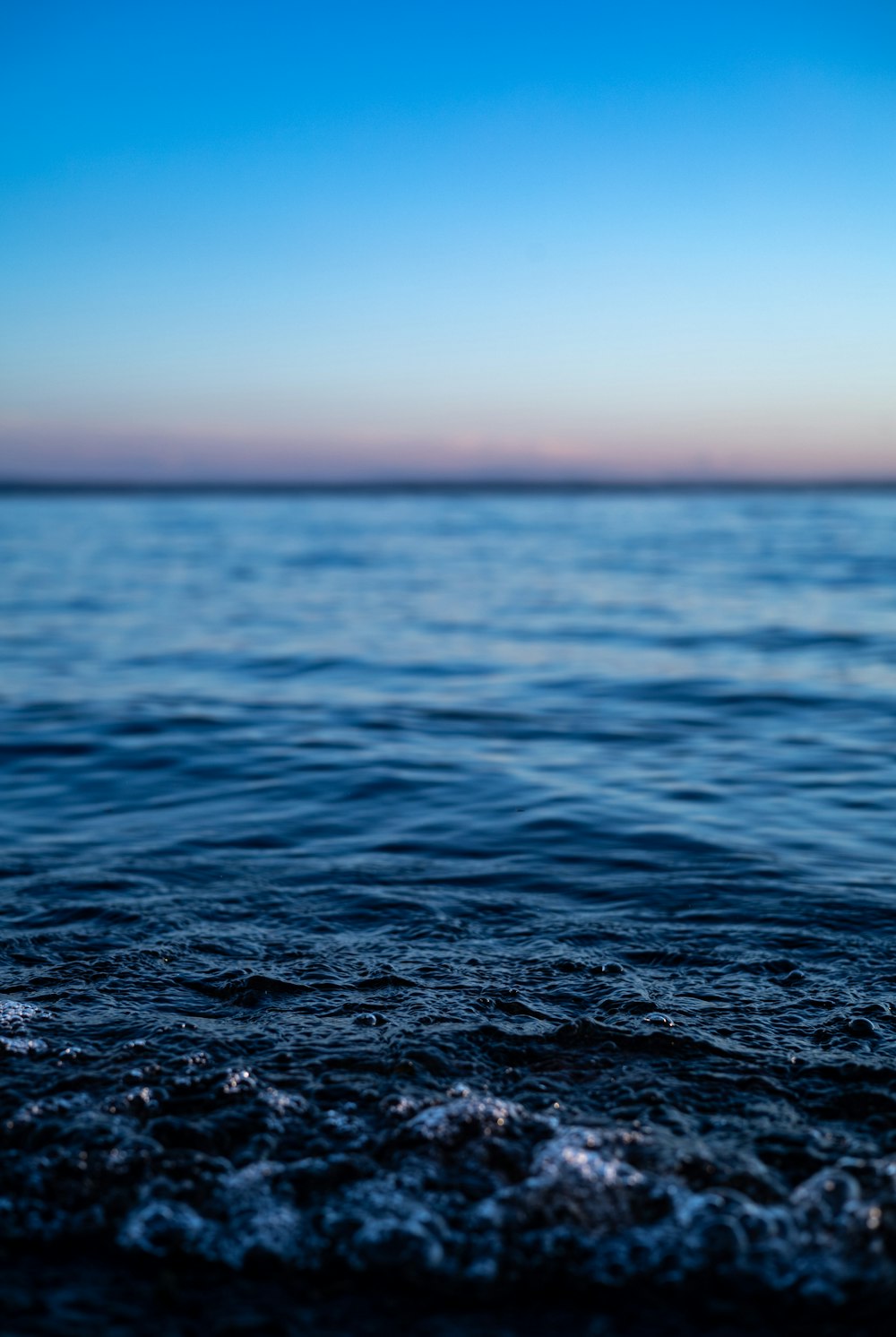 a body of water with a sky in the background