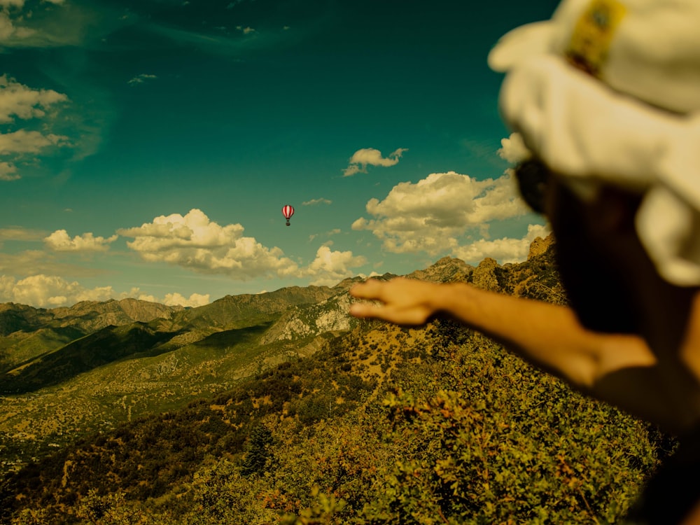 a person is flying a kite high in the sky