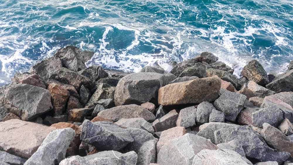 a bunch of rocks that are by the water