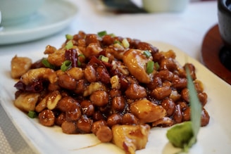 a white plate topped with fried food on top of a table