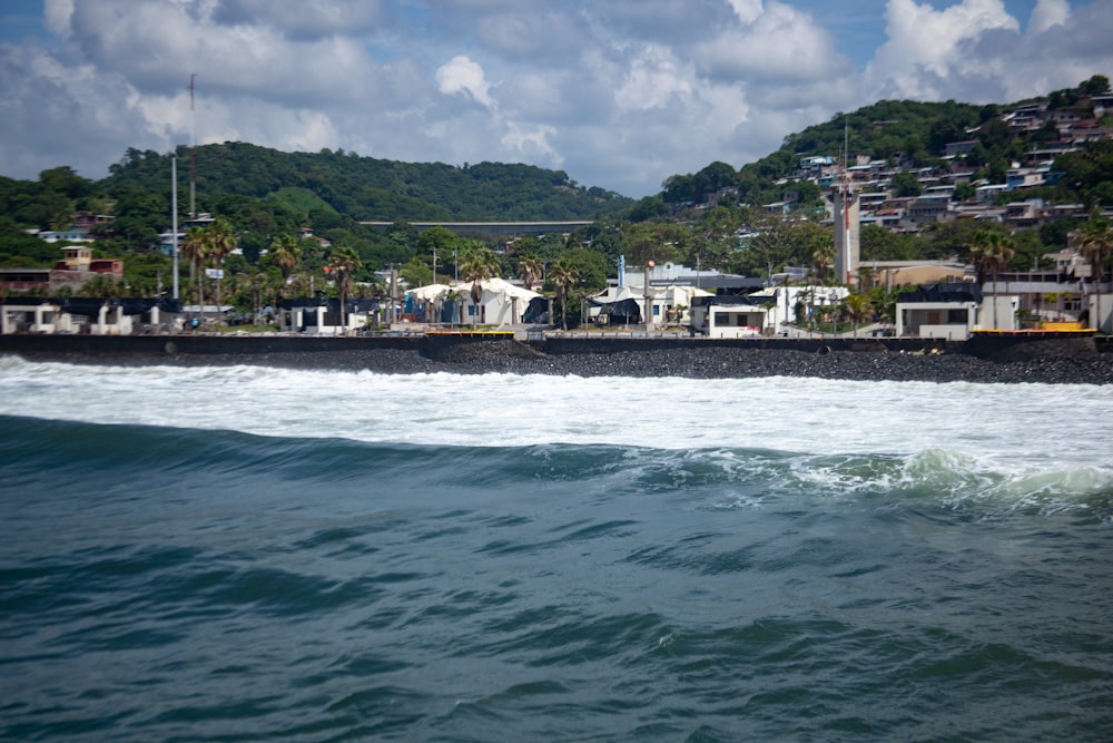 a large body of water with houses in the background