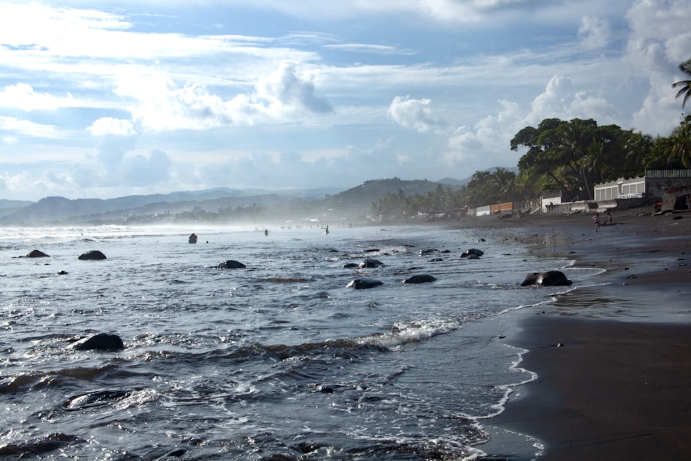 a beach that has some rocks in the water