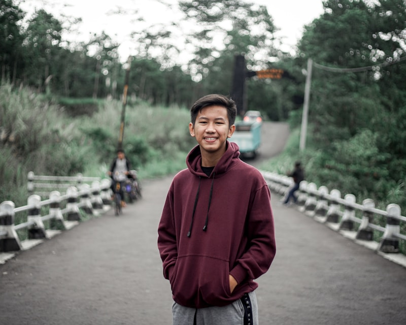 Man posing proudly by bridge