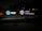 An illuminated signboard displays the AT&T logo, the wording 'AT&T University,' and an emblem with the text 'AT&T University Established 2009.' The sign is positioned outside against a background of trees, and the setting appears to be at night.
