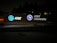 An illuminated signboard displays the AT&T logo, the wording 'AT&T University,' and an emblem with the text 'AT&T University Established 2009.' The sign is positioned outside against a background of trees, and the setting appears to be at night.