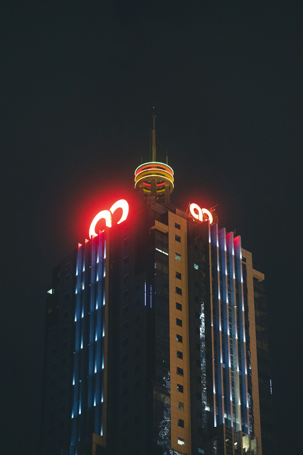 a very tall building with some lights on top of it