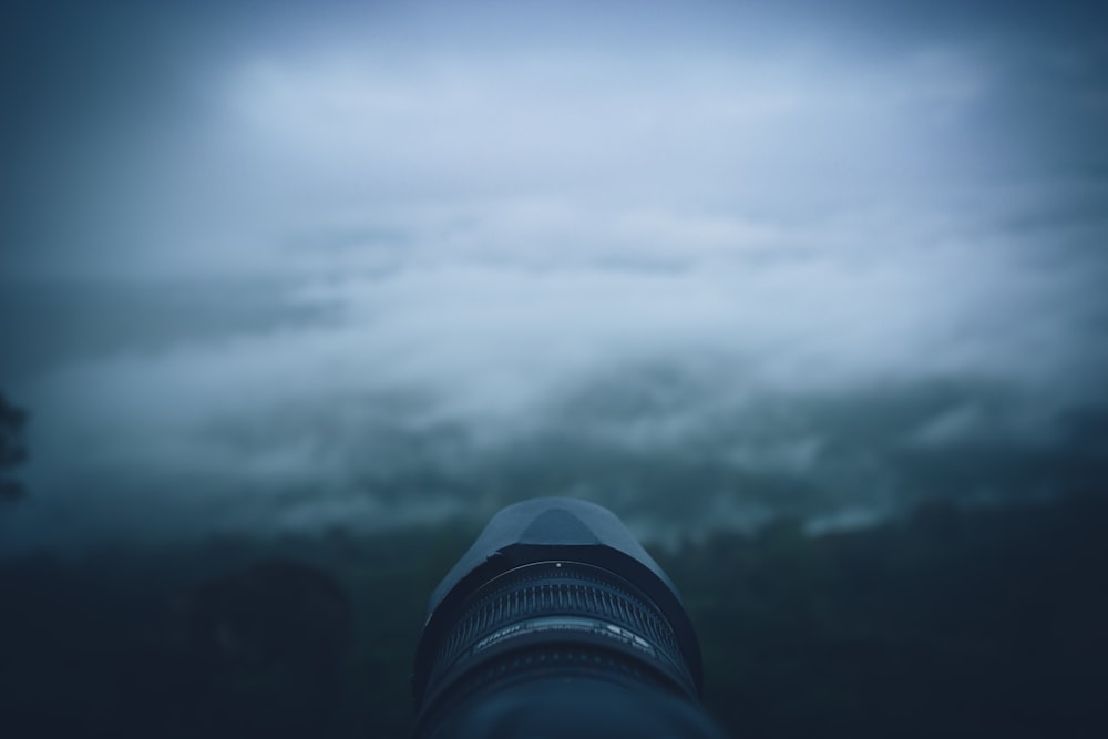 a camera lens with a blurry sky in the background
