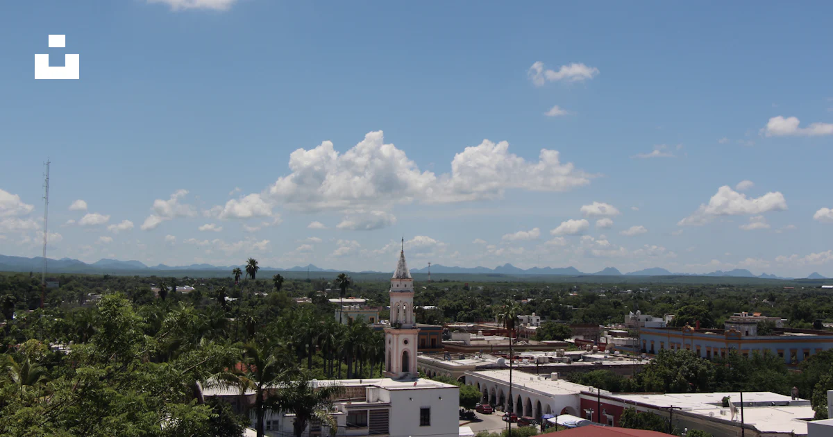 A view of a city with a clock tower photo – Free Building Image on Unsplash