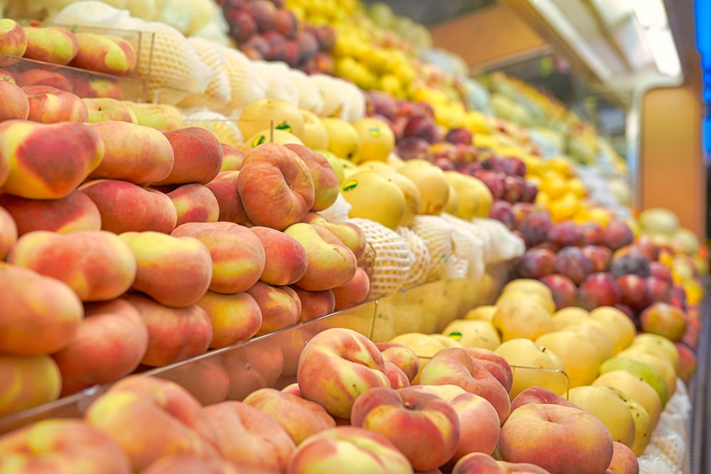 a display in a grocery store filled with lots of fruit